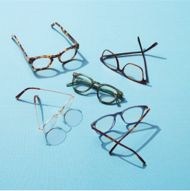 Warby Parker glasses on a blue background