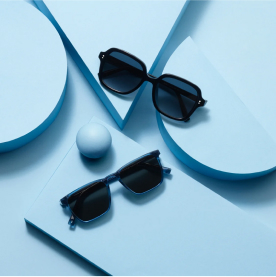 Warby Parker sunglasses on a blue background