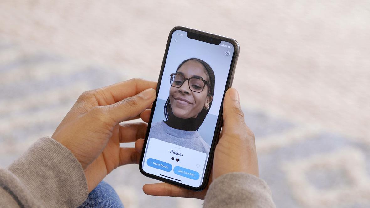 Woman using her phone to virtually try on glasses