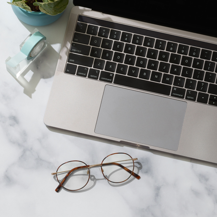 Pair of glasses sitting near a laptop