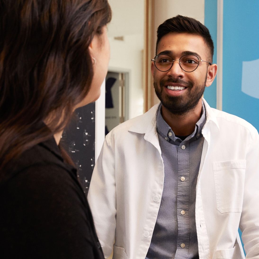 Friendly optometrist in a white coat