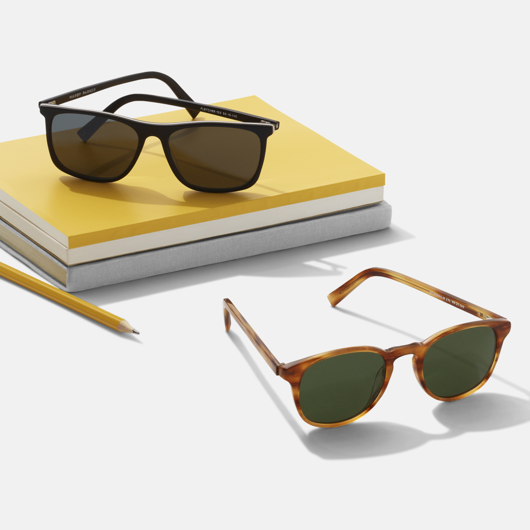 Sunglasses sitting on a stack of books