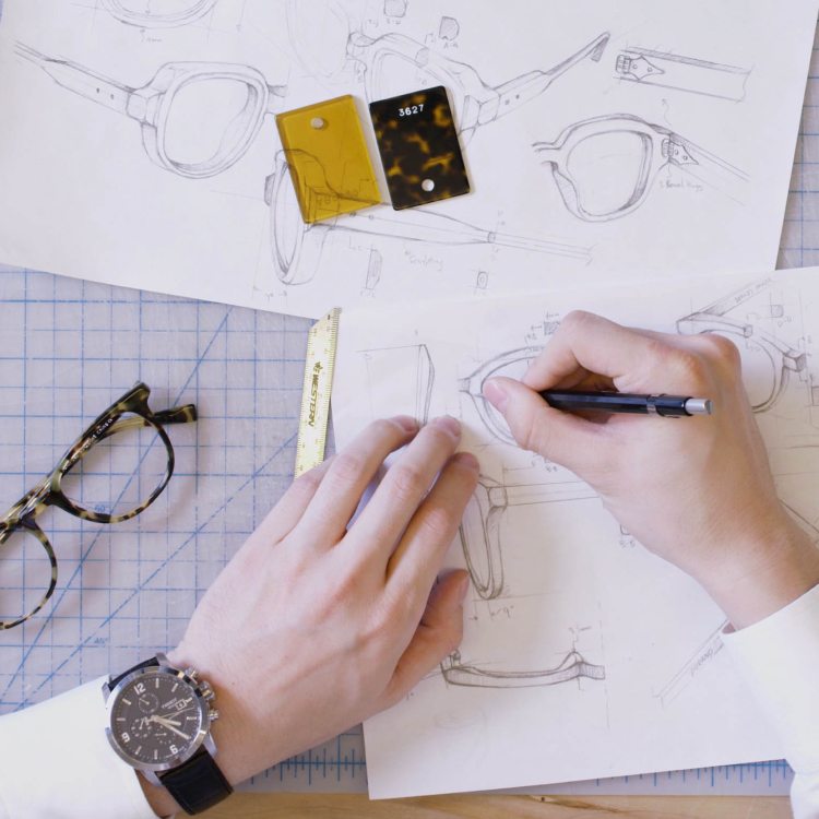 Hands sketching designs for glasses