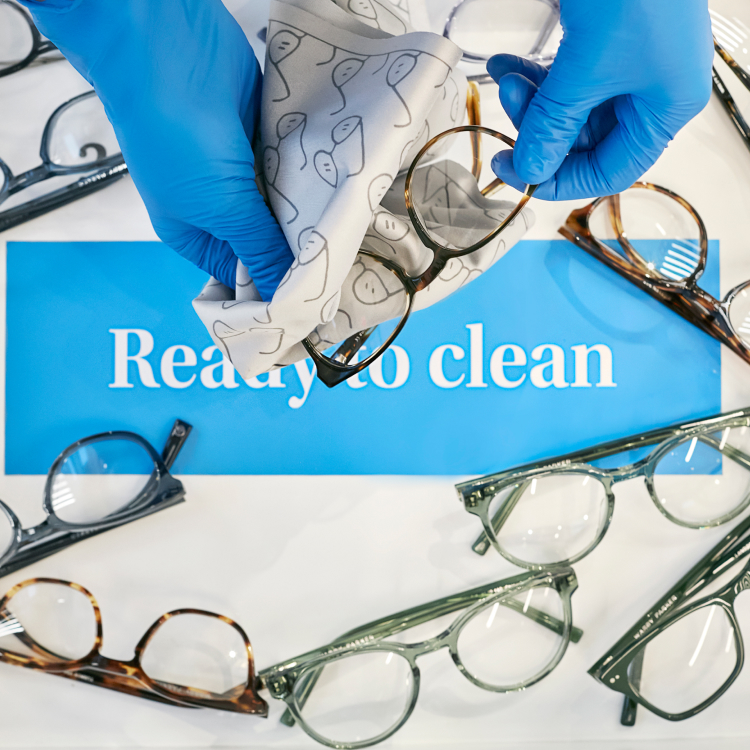 Hands wiping off glasses with a microfiber cloth
