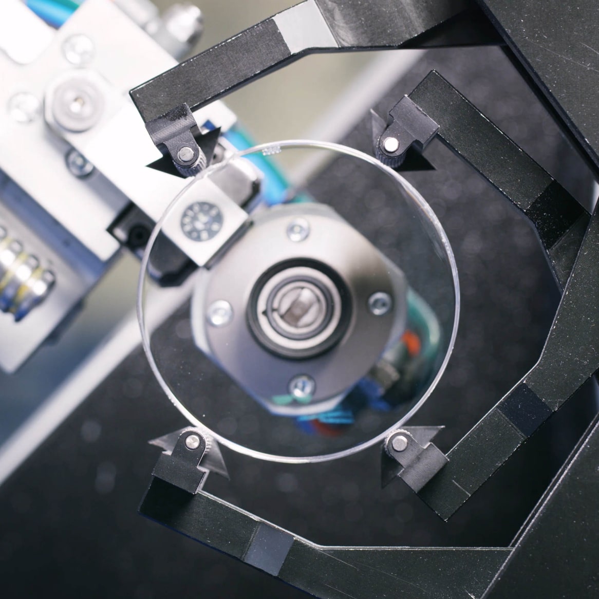 Glasses lens being manipulated by machinery