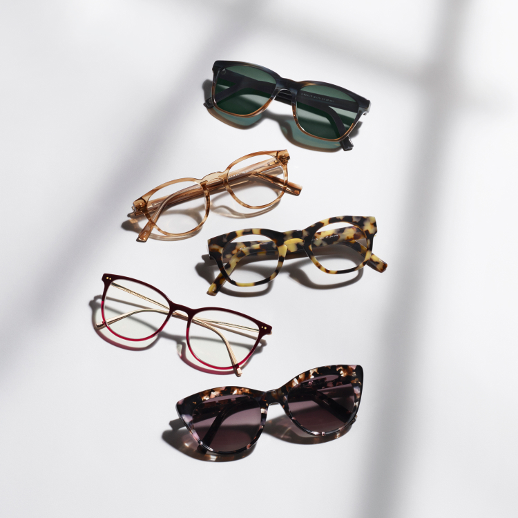 Glasses and sunglasses brightly lit on a white background