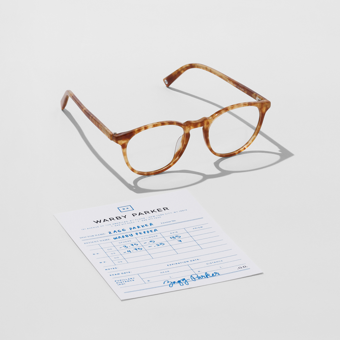 Glasses alongside a prescription for a patient with astigmatism