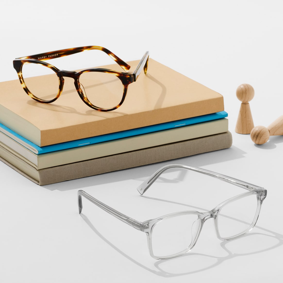 Glasses frames pictured with stack of books