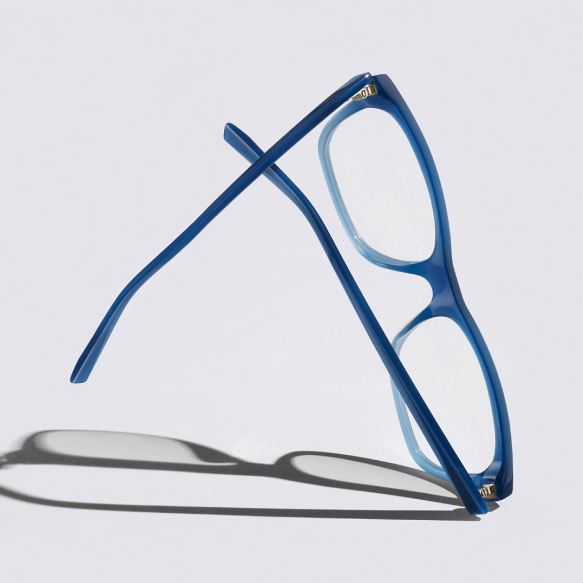Blue pair of glasses with shadow on grey background