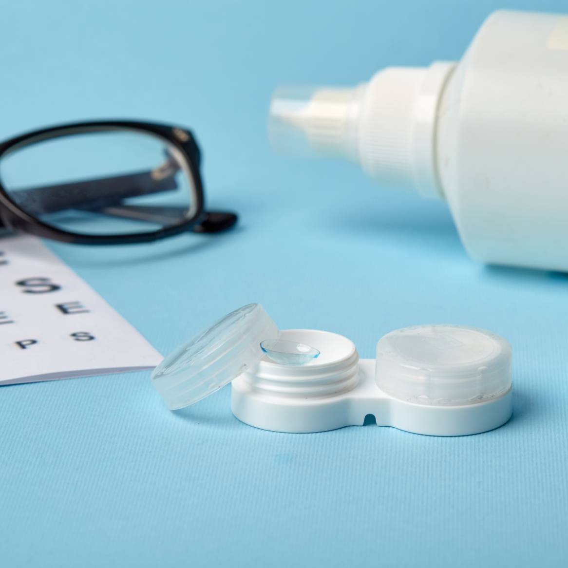 Contact lens case alongside a Snellen chart
