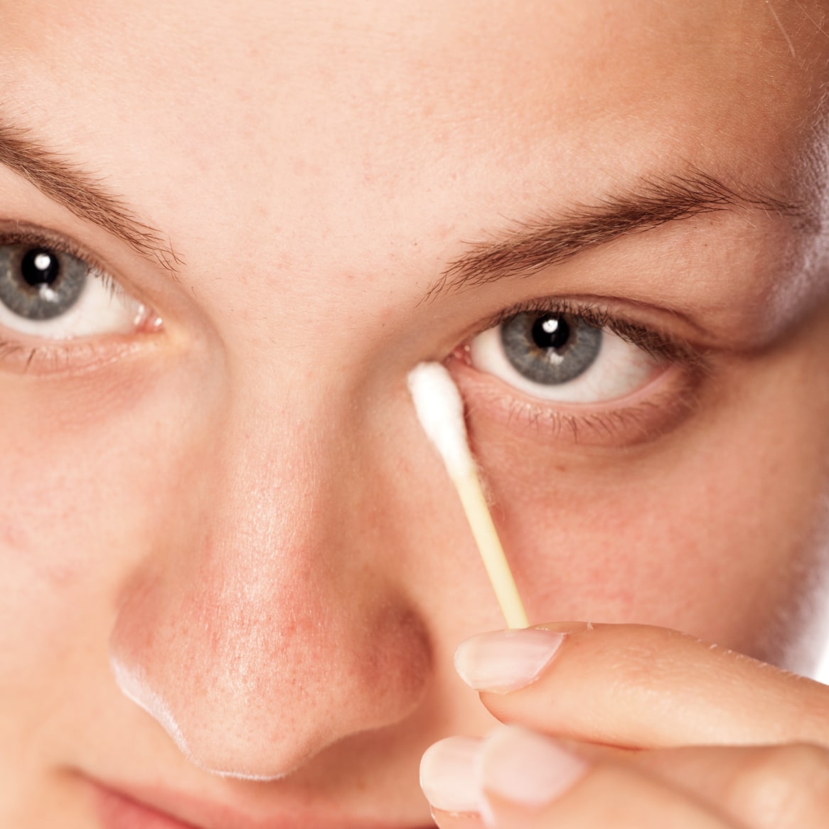 Person holding a cotton swab up to their eye