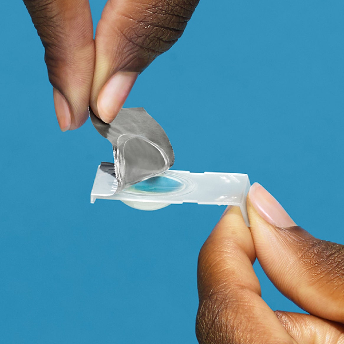 hands opening contact lens blister pack