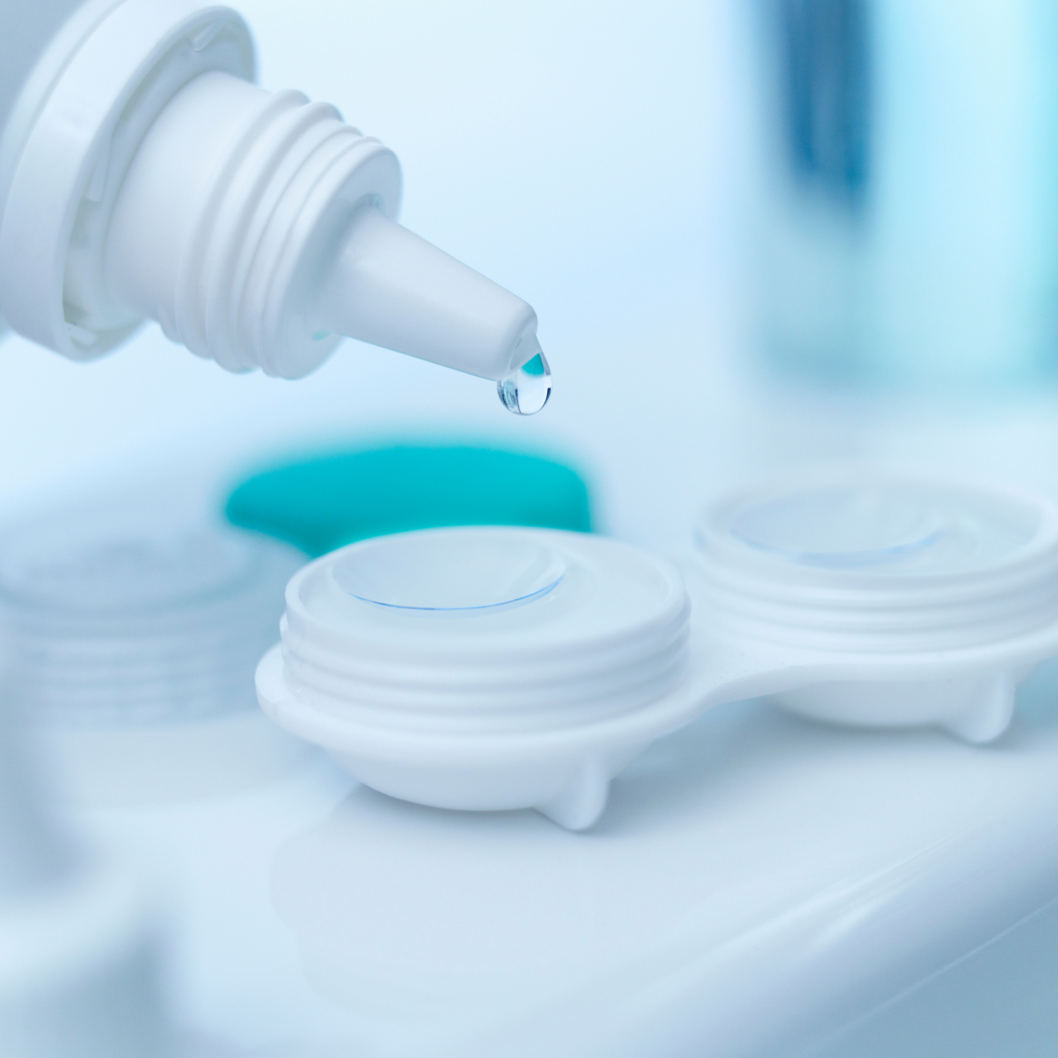 Close-up image of a contact lens being rinsed with saline solution