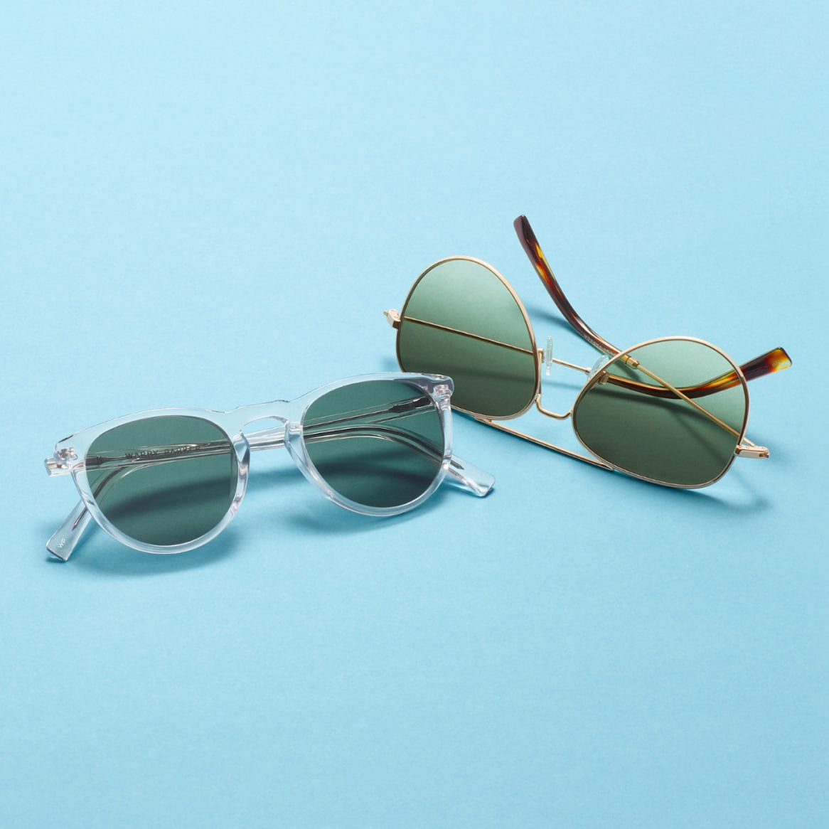 Two pairs of sunglasses on a blue background