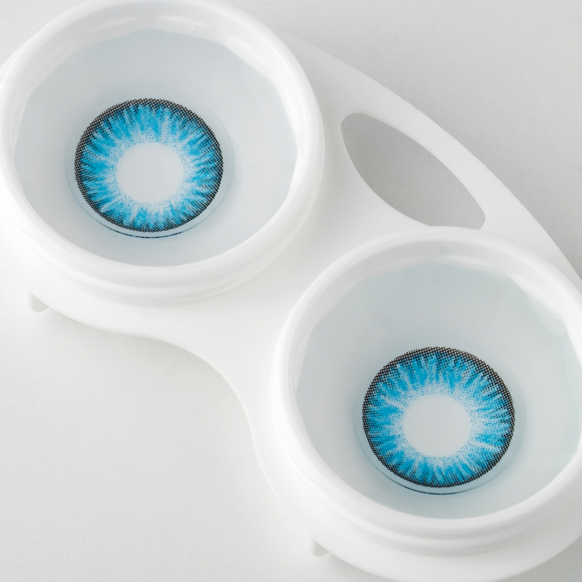 Blue colored contacts in a contact lens case.