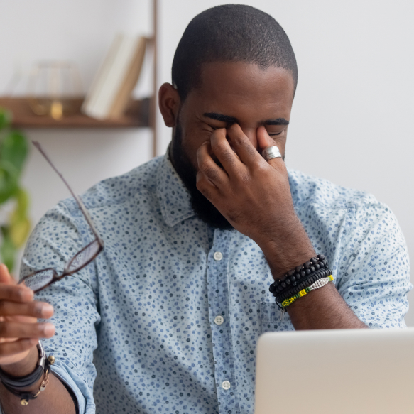 Man with astigmatism having vision issues at computer.