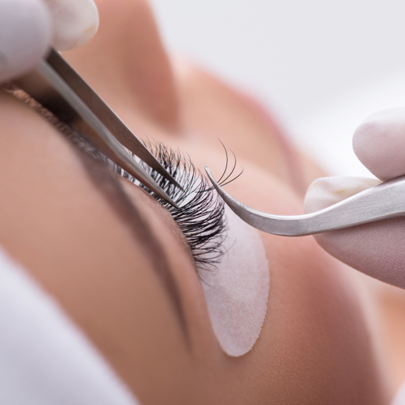 Person getting eyelash extensions safely.