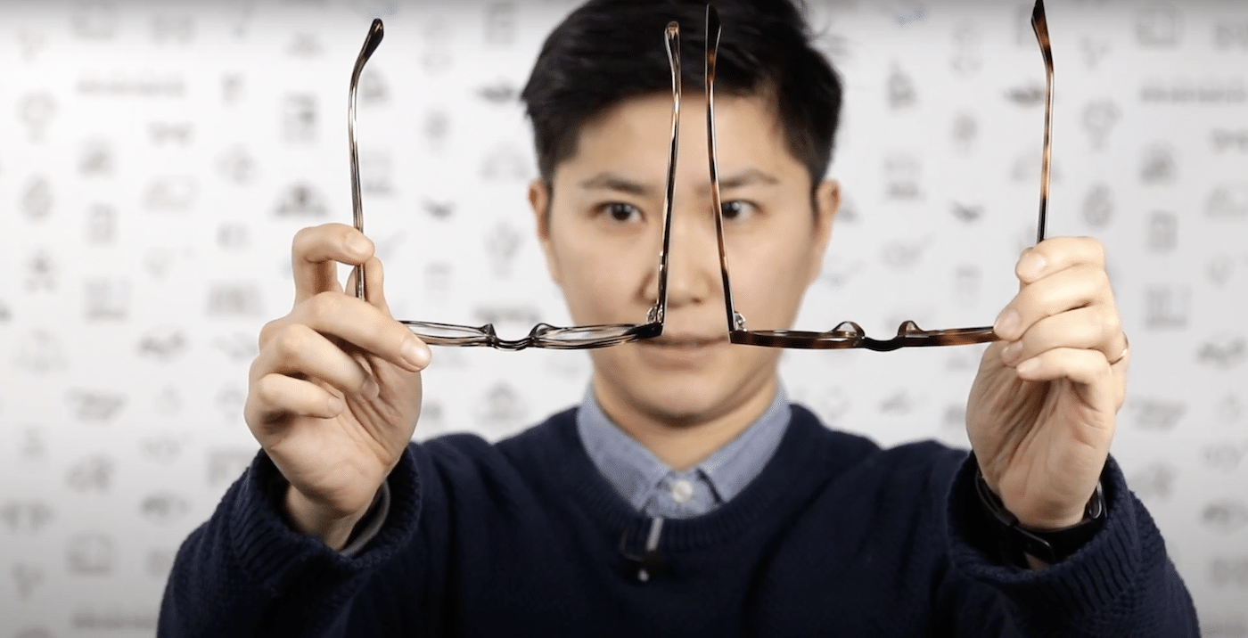 Person comparing standard fit to low bridge fit eyeglasses